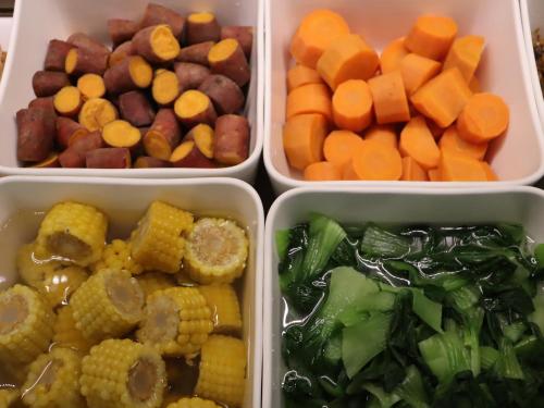 four plastic containers filled with different types of food at JI Hotel Beijing Qianmen Courtyard in Beijing