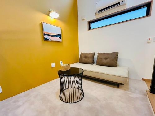 a living room with a couch and a table at Hikarinoyado Yamate - Vacation STAY 18639 in Sasebo