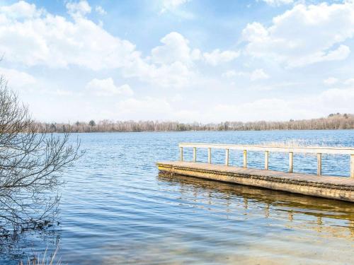a dock on a lake with a cloudy sky at 8 person holiday home in Ansager-By Traum in Ansager