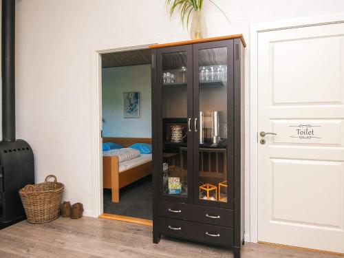 a black cabinet in a room with a bedroom at 8 person holiday home in Ansager-By Traum in Ansager