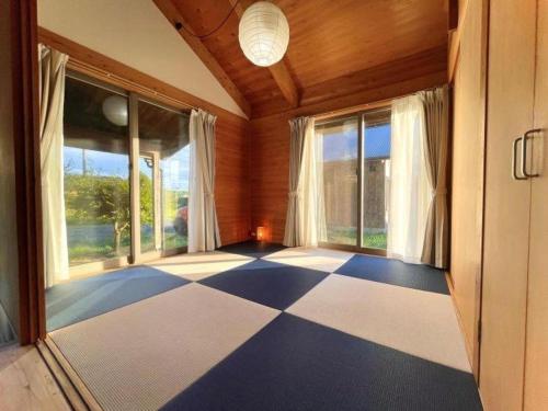 a room with a checkered floor and large windows at Gubo Satoyama Suite Lodge & Camp - Vacation STAY 39510v in Katsuura