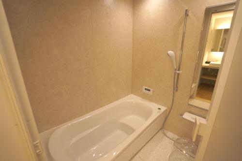 a bathroom with a bath tub and a shower at Mitsuka Building - Vacation STAY 43030v in Kofu