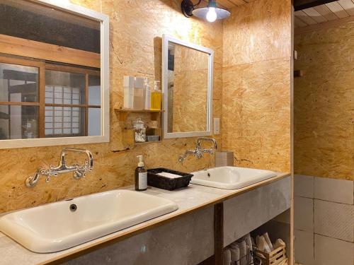 a bathroom with two sinks and a mirror at La Cachette - Vacation STAY 45323v in Ina