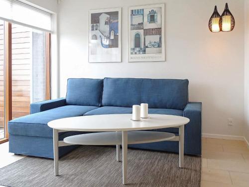 a living room with a blue couch and a table at 4 person holiday home in Bogense-By Traum in Bogense