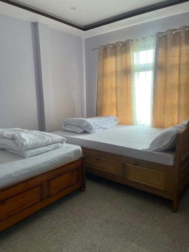 Ένα ή περισσότερα κρεβάτια σε δωμάτιο στο Kaushi Homestay