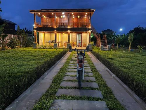 a motorcycle parked in front of a house at night at Vvillage 