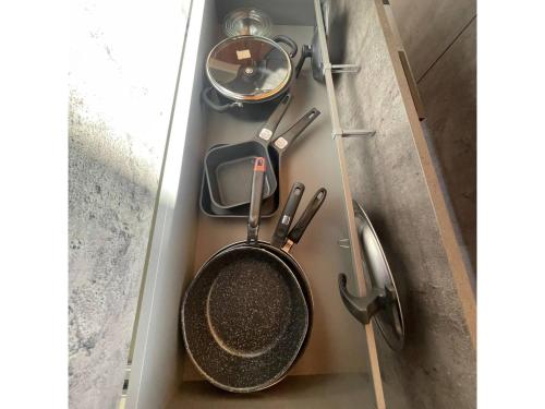 a pan and utensils are sitting in a drawer at Shirahama Village - Vacation STAY 52778v in Minamiboso