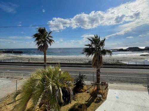 a view of a beach with palm trees and a road at Shirahama Village - Vacation STAY 52778v in Minamiboso