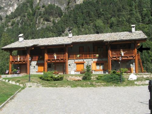 a large wooden house with a balcony on a mountain at Apartment in Antey-Saint-André near Ski Area in Antey-Saint-André