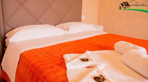 מיטה או מיטות בחדר ב-La Villetta Sul Mavone