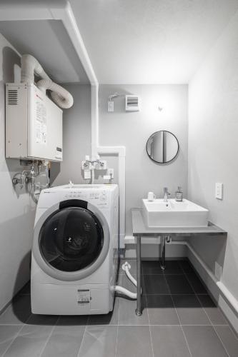 a washing machine in a bathroom with a sink at AKATSUKI - Vacation STAY 18831 in Kami-furano