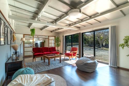 a living room with red chairs and a couch at Asahi - House - Vacation STAY 18691 in Asahi