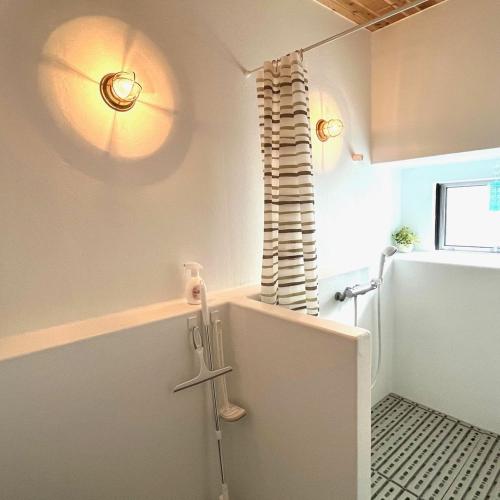 a bathroom with a walk in shower next to a window at Fujiminchi Inn - Vacation STAY 65731v in Fujimi