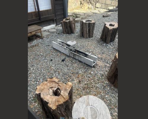 a piece of metal laying on the ground next to some logs at Fujiminchi Inn - Vacation STAY 65731v in Fujimi