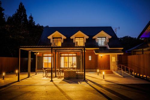 a house with a large front yard at night at Orihimekan - Vacation STAY 70154v in To-katta