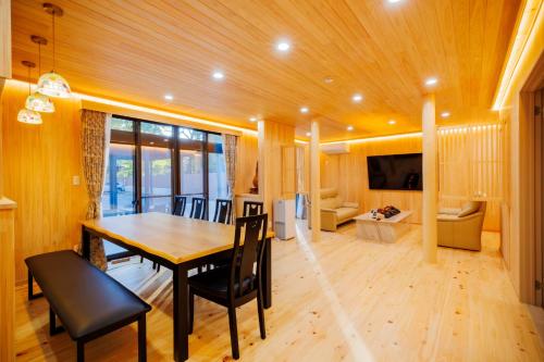 a dining room with a table and chairs and a living room at Orihimekan - Vacation STAY 70154v in To-katta
