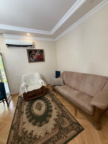 a living room with a couch and a rug at gaydi in Gori