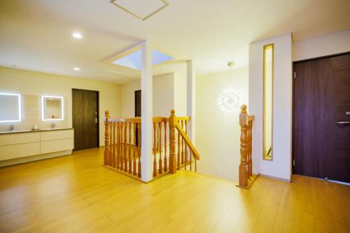 a living room with a staircase and a kitchen at Orihimekan - Vacation STAY 70154v in To-katta
