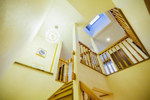 a hallway with wooden stairs and a large window at Orihimekan - Vacation STAY 70154v in To-katta