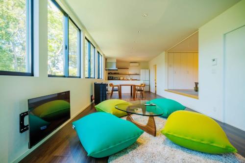 a living room with green and yellow chairs and a television at Villa Zao - Vacation STAY 73045v in To-katta