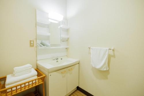 a white bathroom with a sink and a mirror at kominka Higurashi-an - Vacation STAY 18803 in To-katta