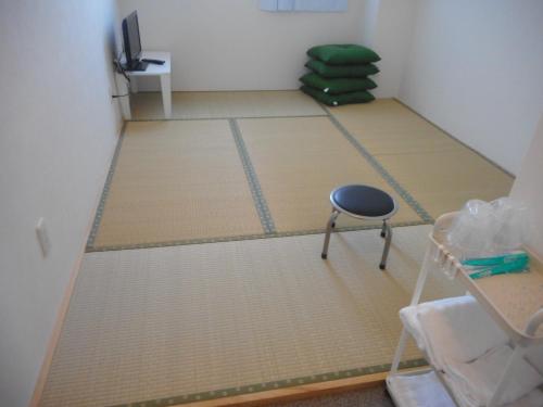 a room with a ping pong table and a chair at Youth Hostel KiKai - Vacation STAY 86049v in Akaren