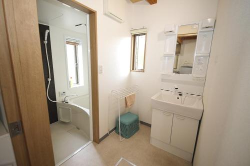 a bathroom with a sink and a toilet and a mirror at Ryuyo Marine Park Auto Campsite - Vacation STAY 78095v in Kaketsuka