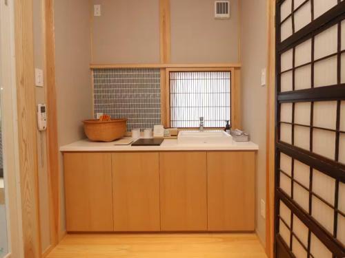 a small kitchen with a sink and a window at A-UN INN - Vacation STAY 84863v in Aizuwakamatsu