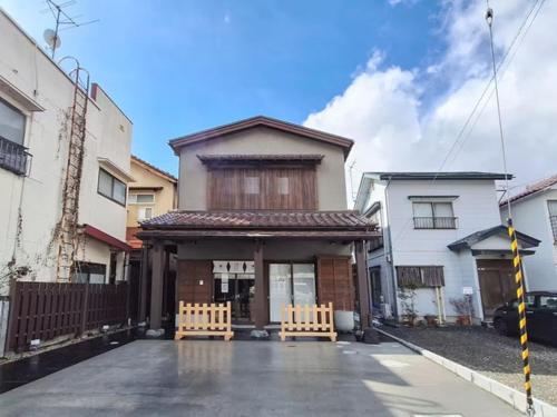 a house with two benches in front of it at A-UN INN - Vacation STAY 84863v in Aizuwakamatsu