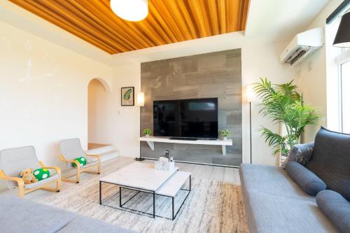 a living room with a couch and a tv at Bridge View Villa - Vacation STAY 80945v in Awaji
