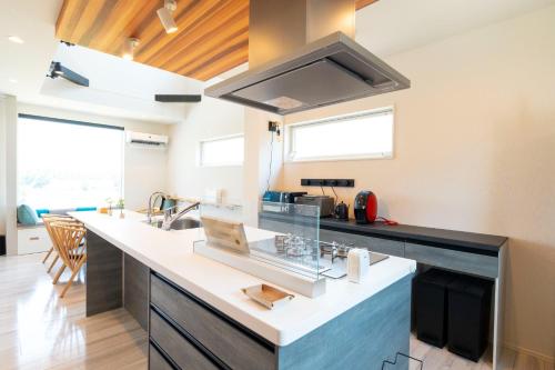 a kitchen with a large counter with a sink at Bridge View Villa - Vacation STAY 80945v in Awaji