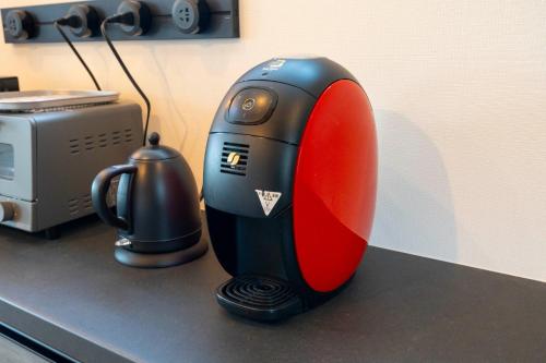 a red and black blender sitting on top of a counter at Bridge View Villa - Vacation STAY 80945v in Awaji