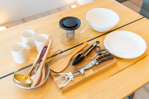a wooden table with bowls and utensils on it at Bridge View Villa - Vacation STAY 80945v in Awaji