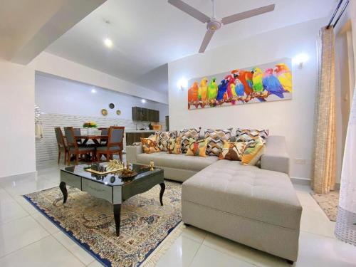 a living room with a couch and a table at kisimani Nest in Mombasa