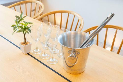 a bucket on a table with wine glasses and a plant at Bridge View Villa - Vacation STAY 80945v in Awaji