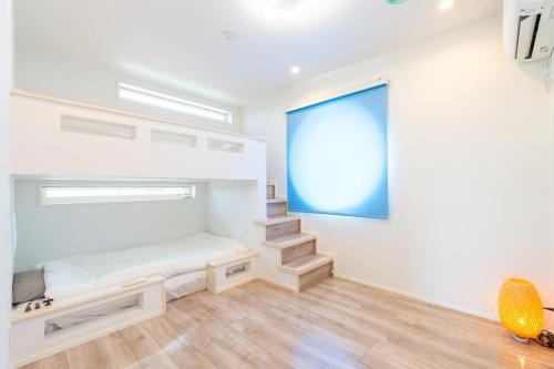 a room with a bed and stairs in it at Bridge View Villa - Vacation STAY 80945v in Awaji