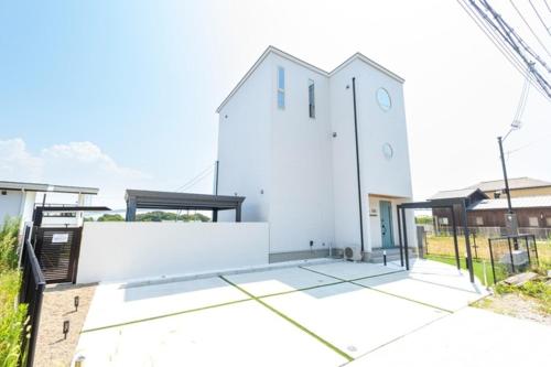 a white building with a clock on the side of it at Bridge View Villa - Vacation STAY 80945v in Awaji