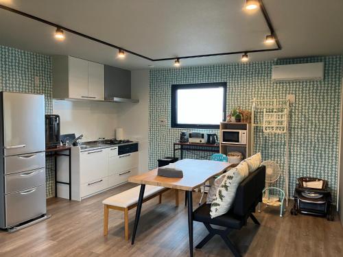 a kitchen with a table and a dining room at urumare - Vacation STAY 85310v in Teruma