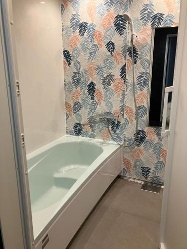 a bathroom with a bath tub and a shower at VILLA PRECI - Vacation STAY 85974v in Teruma