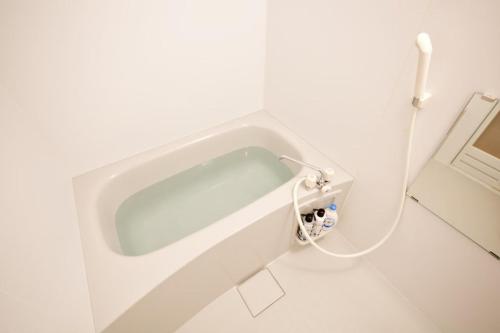 a white bathtub in a white bathroom with at Plus Life Ohama - Vacation STAY 85882v in Miyara