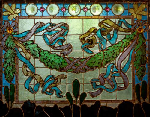 a stained glass picture of a fish on a wall at Hellidens Slott in Tidaholm