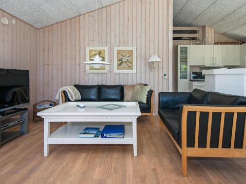 a living room with a couch and a table at 8 person holiday home in Ulfborg in Ulfborg