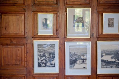 a group of pictures on a wooden wall at Hellidens Slott in Tidaholm