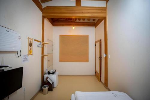 a hospital room with a bed and a window at Nabijam Hanok Hotel in Jeonju