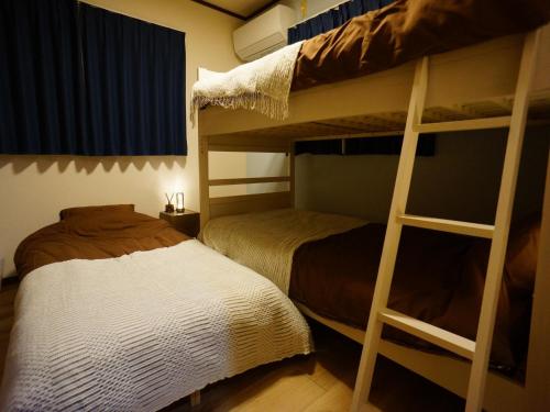 a bedroom with two bunk beds and a bed at Shareable Suzuka - Vacation STAY 18982 in Suzuka