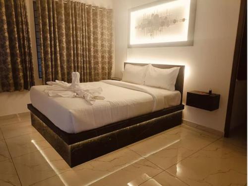 a bedroom with a bed with a white blanket at Le Park Luxury Resort - TIE Hotels & Resorts in Puducherry
