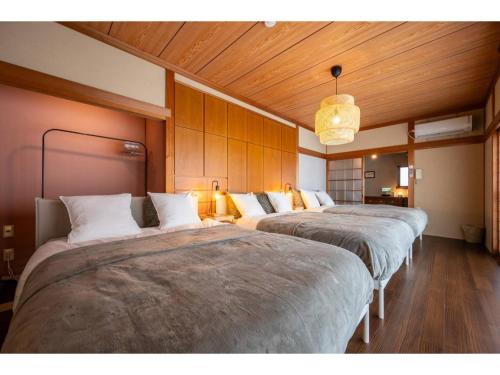 a row of three beds in a room at WaKaRaN9111 - Vacation STAY 93587v in Nagasaki