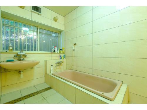 a bathroom with a bath tub and a sink at Miura Bambino - Vacation STAY 19001 in Miura