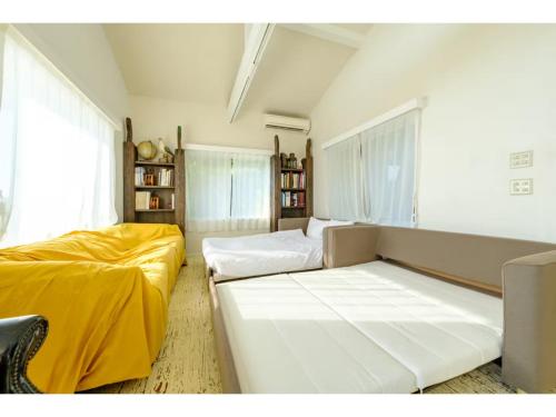 a room with two beds and a couch at Miura Bambino - Vacation STAY 19001 in Miura