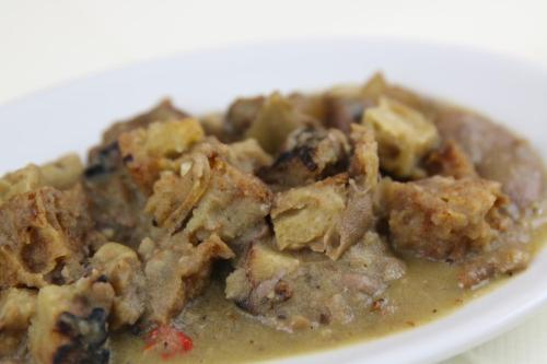 a white plate of food with meat and gravy at Agriturismo Fasano in Cassano delle Murge